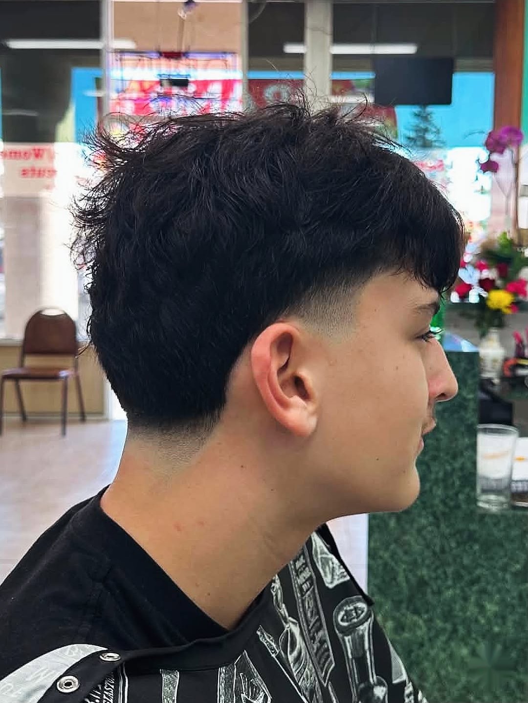 Edgar cut with a low taper fade and textured fringe, scissor-cut top, done at Royal Luxe Cutz barbershop in Fremont, CA